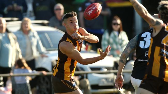 Jordan Vellios fires off a handball for Heidelberg West. Picture: Hamish Blair