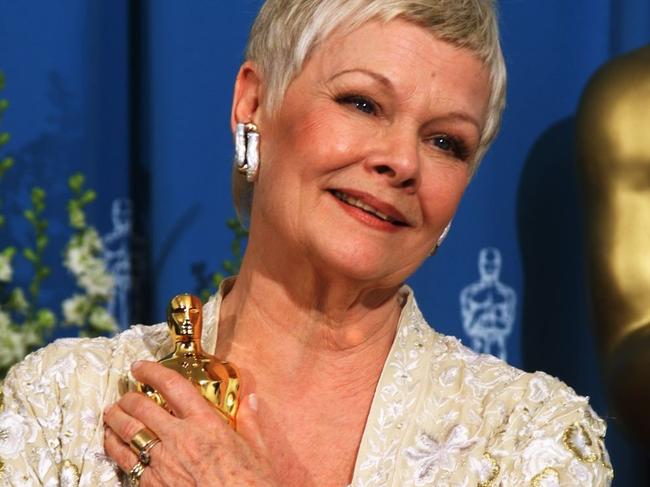 Judi Dench holds her Oscar for Best Supporting Actress in 1999. Picture: AFP.