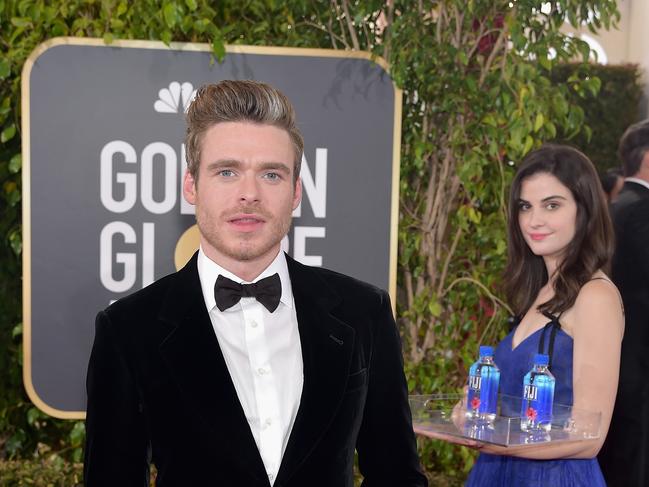 Richard Madden had an unexpected photobomber. Picture: Stefanie Keenan/Getty Images for FIJI Water