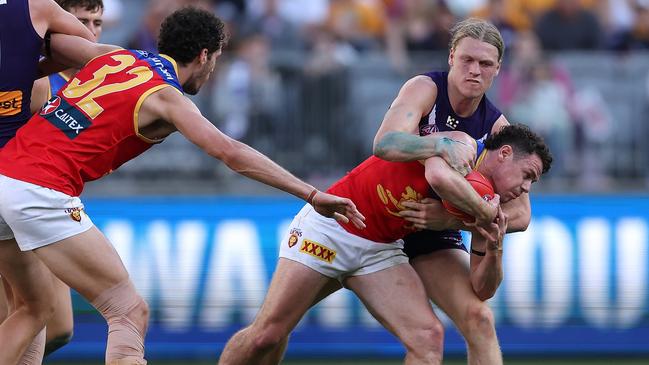 Lion Lachie Neale is held up by Fremantle’s Hayden Young during their clash at Optus Stadium, on August 06, 2023, in Perth, Australia. (Photo by Paul Kane/Getty Images)