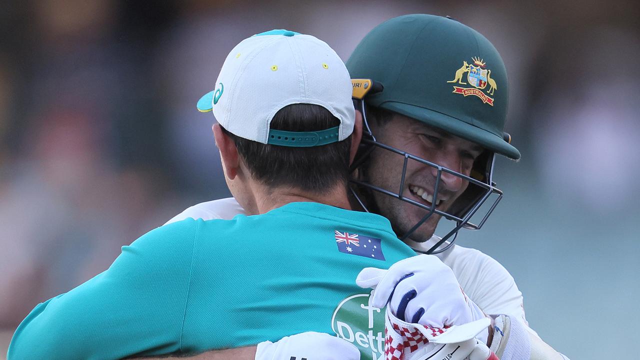 Joe Burns is embraced by Justin Langer after guiding the Aussies to victory against India in the first Test. Picture: Getty Images