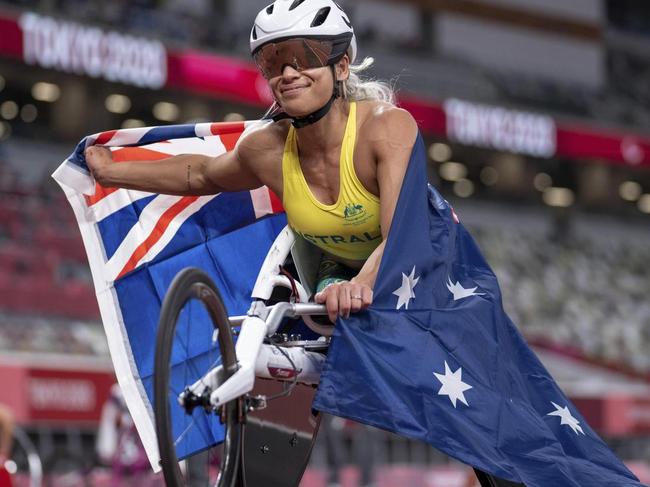 Madison De Rozario of Australia poses with the national flag of Australia after winning the women's 800-meter - T53 final at the Olympic Stadium during the Tokyo 2020 Paralympic Games. Picture: AP