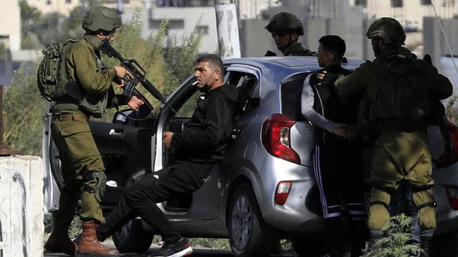 Israeli soldiers detain Palestinians after stopping their car near the Huwara checkpoint at the southern entrance to Nablus city in the occupied West Bank on Friday. Picture: Zain Jaafar/AFP