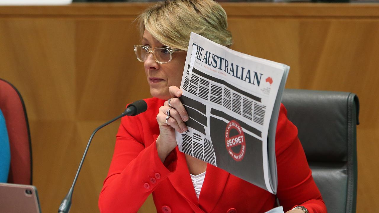 Kristina Keneally holding up the front pages of the papers as she asks questions at a Senate Estimates hearing on Legal and Constitutional Affairs at Parliament House in Canberra. Picture: Kym Smith