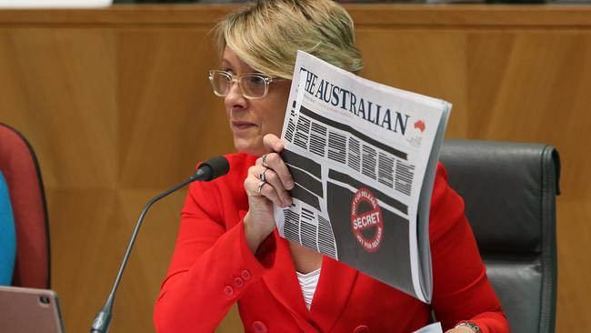 Kristina Keneally holding up the front pages of the papers as she asks questions at a Senate Estimates hearing on Legal and Constitutional Affairs at Parliament House in Canberra. Picture: Kym Smith