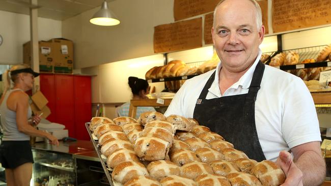 Owner and baker at Brewbakers, Richard Cotton, poses with Hot Cross Buns in Brisbane, Wednesday, April 3, 2019. Brewbakers is attempting for the first time to make sourdough hot crossed buns. (AAP Image/Jono Searle)