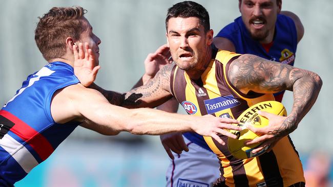 AFL - Sunday, 13th September, 2020 - Hawthorn v Western Bulldogs at the Adelaide Oval. Hawthorn's Chad Wingard tries to break the tackle of Western Bulldogs Lachie Hunter Picture: Sarah Reed