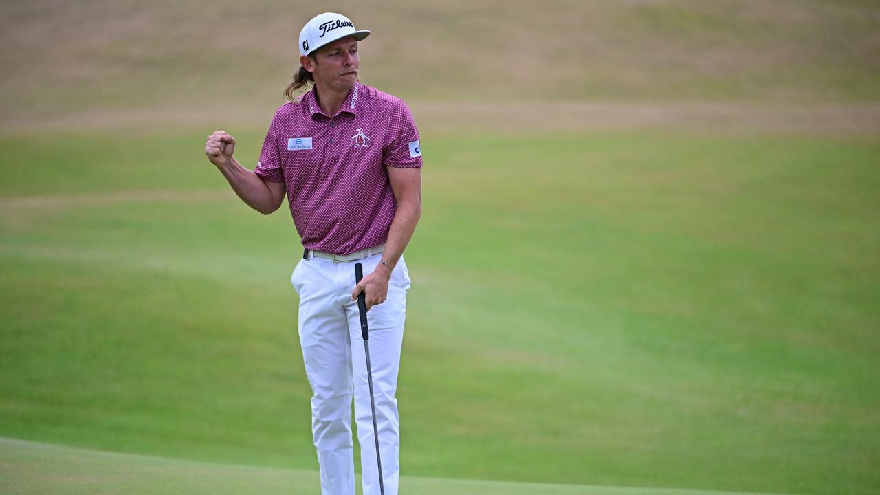 Australia's Cameron Smith celebrates after holing his final putt to make a birdie on the 18th green during his final round 64 on day 4 of The 150th British Open Golf Championship on The Old Course at St Andrews in Scotland on July 17, 2022. (Photo by Andy Buchanan / AFP) / RESTRICTED TO EDITORIAL USE