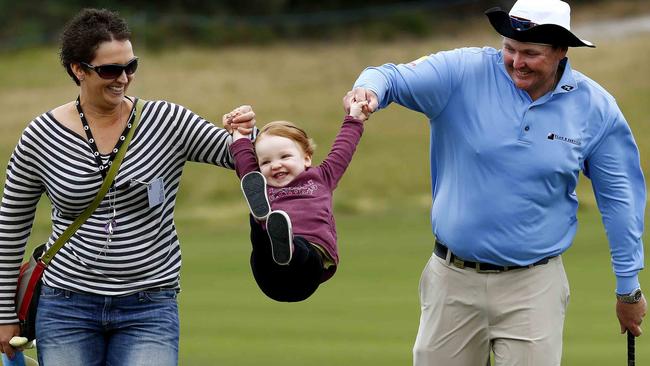 Jarrod Lyle walks the fairways with his wife Briony and daughter Lush at an Australian Masters practice day back in 2013. Pic Michael Klein.