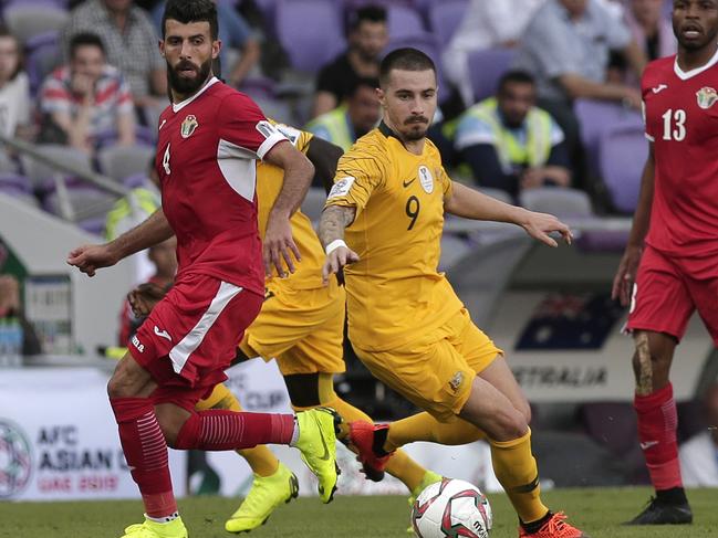 Socceroos striker Jamie Maclaren on the ball ahead of Jordan midfielder Bahaha Abdel-Rahman during Australia’s first game at the Asian Cup in the UAE. Picture: AP 