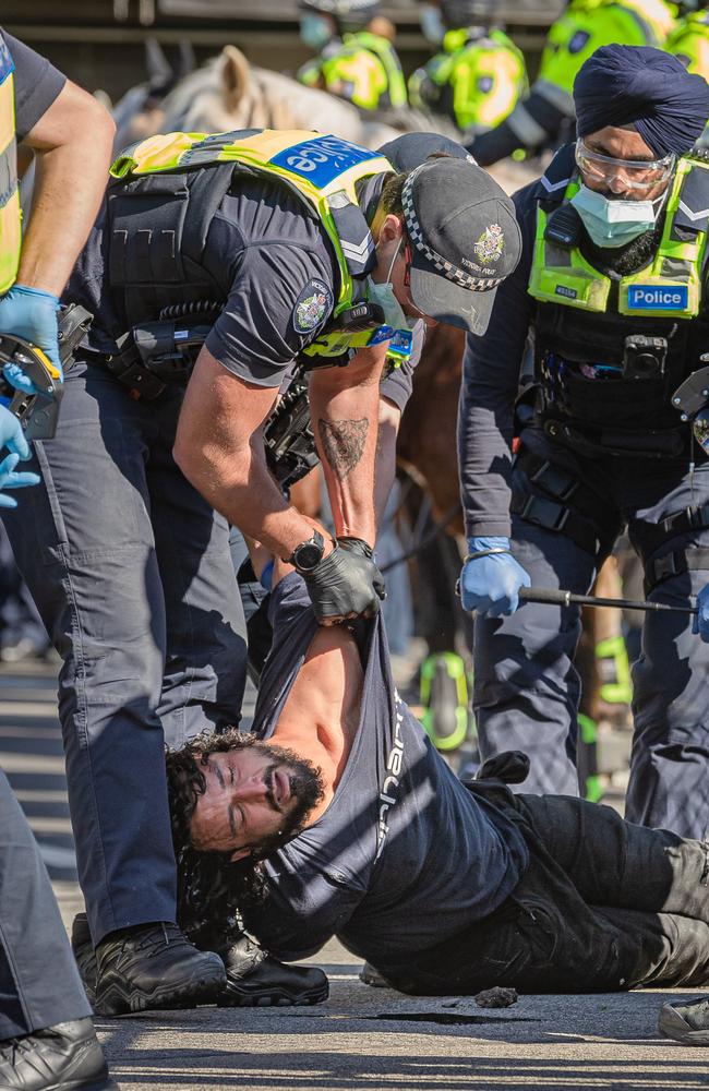 A protester is taken into police custody. Picture: Jason Edwards