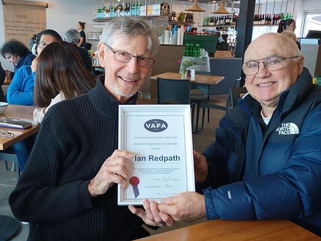 Ian Redpath with former VAFA president George Voyage and the framed certificate for his service to the association - plus the reinstatement of his playing permit. Picture: Paul Amy