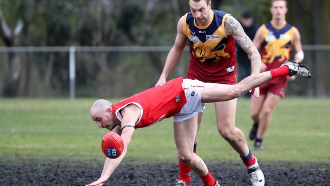 Sean Calcedo displays his tenacious approach, diving head first at the footy against Therry Penola.