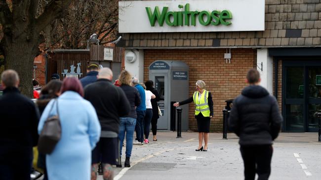 Locals queue outside Waitrose supermarket in Frimley, south west of London, as life in Britain continues during the nationwide lockdown Picture: Adrian Dennis/AFP