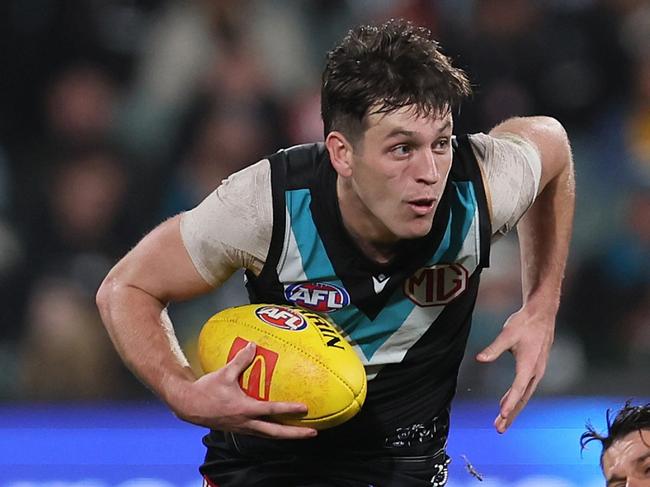 ADELAIDE, AUSTRALIA - JULY 20: Dion Prestia of the Tigers tries to tackle Zak Butters of the Power during the 2024 AFL Round 19 match between the Port Adelaide Power and the Richmond Tigers at Adelaide Oval on July 20, 2024 in Adelaide, Australia. (Photo by James Elsby/AFL Photos via Getty Images)