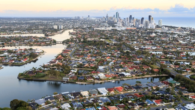 The canals and city edge seen at sunrise from a hot air balloon, the Gold Coast, QLD.