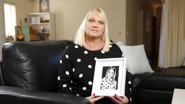 Kirsten McGinty holds a photo of Zoeat her home in Clayfield. Picture: AAP Image/Josh Woning