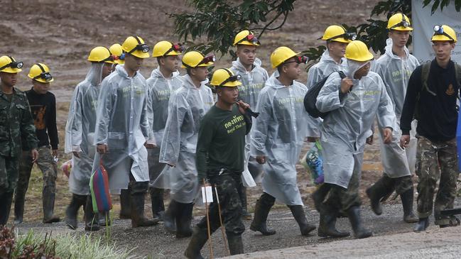 Rescuers walk toward the Tham Luang cave entrance. Picture: AP