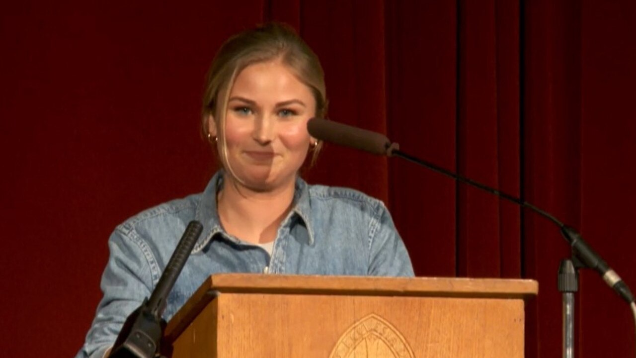 Grace Tame speaking at her old school.