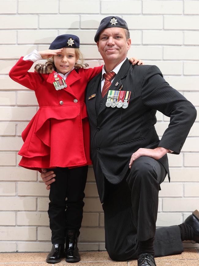 Lilly-rose Storey, 7, with her father Flash Storey, 50, from Everton Hills at the ANZAC Day march, Brisbane. Picture: Liam Kidston
