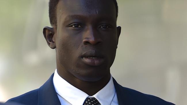 AFL footballer Majak Daw arrives at the County Court in Melbourne, Monday, Nov. 30, 2015. 24-year-old Daw is facing three charges over an alleged rape of a 15 year old girl at a party in Melbourne's west in March 2007. (AAP Image/Tracey Nearmy) NO ARCHIVING