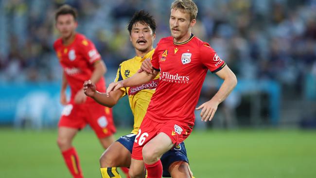 Ben Halloran of Adelaide United contests the ball with Eunsun Kim of the Central Coast Mariners. Picture: Tony Feder/Getty Images.