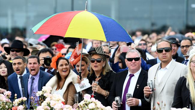 Racegoers prepared for all weather. Picture: AAP