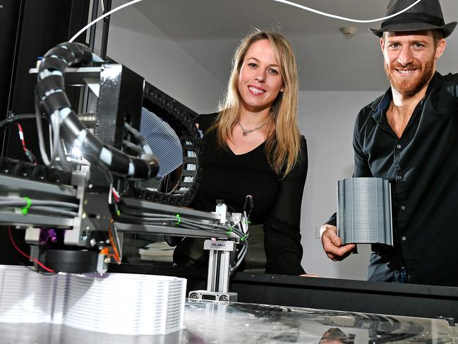 Mathilde Desselle of Metro North and Victor Vicario of Arc Hardware Incubator show one of the new 3D printers.Arc Hardware Incubator has turned its 3D printer factory to producing Covid-19 faceshields.Monday April 6, 2020. (AAP image, John Gass)