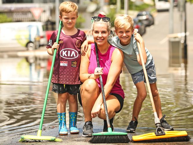 Business owner Jessika Brigginshaw alongside sons Kruze, 5, and Tyler, 8, as they begin the clean-up in Rosalie Village. Picture: Zak Simmonds