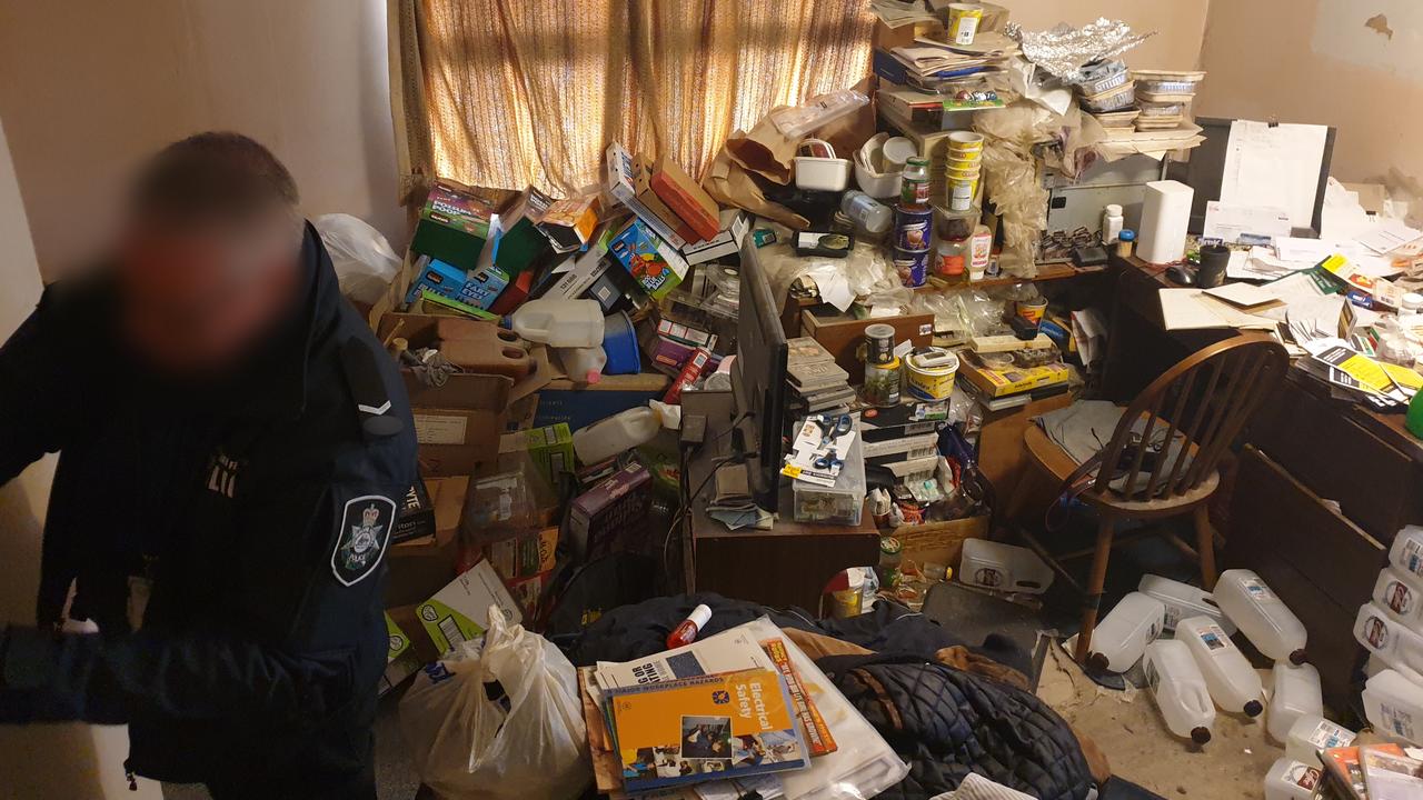 Police officers search the home of Elizabeth man and pedophile Andrew William Richards, who directed the abuse of children overseas via the internet. Picture: AFP