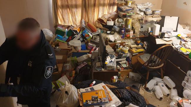 Police officers search the home of Elizabeth man and pedophile Andrew William Richards, who directed the abuse of children overseas via the internet. Picture: AFP