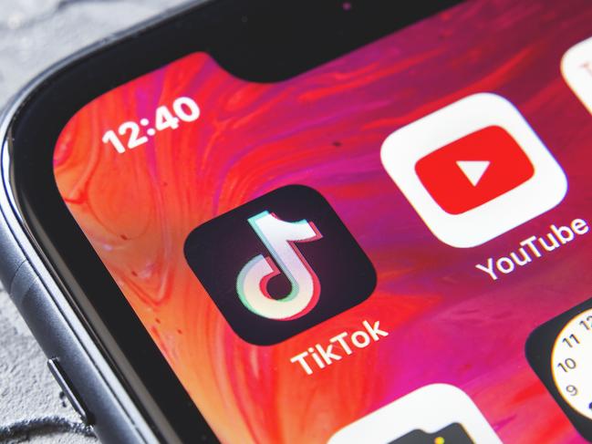 TikTok and YouTube apps on screen iphone xr, close up