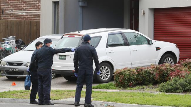 Police at a crime scene in Epping where shots were fired into a car and house. Picture: David Crosling