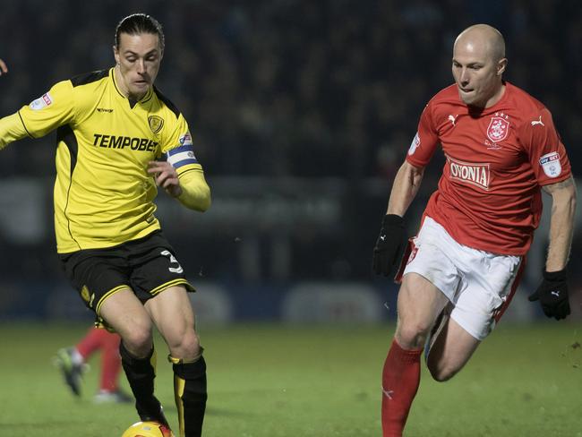 Jackson Irvine (left) in action for Burton Albion against Aaron Mooy of Huddersfield last season. When Irvine returns to the Championship he’ll be playing for Hull City.