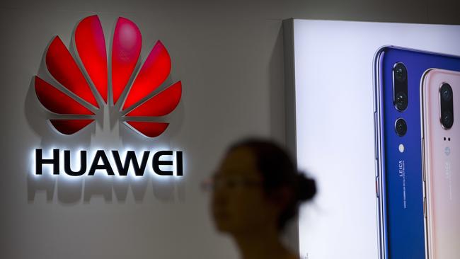 A shopper walks past a Huawei store at a shopping mall in Beijing Wednesday, July 4, 2018. China has produced success stories including Huawei Technologies Ltd., the biggest global seller of switching gear for phone companies and the No. 3 smartphone brand. The company has developed its own Kirin line of chip sets to power some of its phones, reducing reliance on U.S.-based Qualcomm Corp.â€™s Snapdragon and other foreign suppliers. (AP Photo/Mark Schiefelbein)