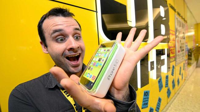 APPLE MADNESS: JB Hi-Fi's Telco Sales representative Matt Cooper gets excited about all apple devices and can barely contain his excitement as rumours of the launch of new iPhone 6 loom.Photo: Max Fleet / NewsMail. Picture: Max Fleet BUN080814JBH1