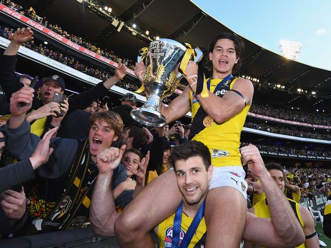 Cotchin and Rioli of the Tigers celebrate