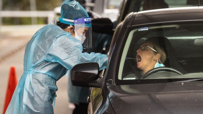 A health worker takes a COVID-19 swab in Sydney. Picture: Julian Andrews