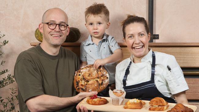 Rik and Alex-Andrea Fisher with their son 2 year old Ash in their cafe 30 Acres Norwood. Picture: Emma Brasier