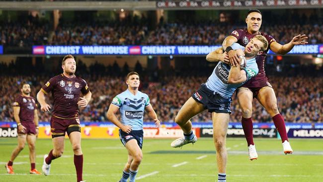 Tom Trbojevic beats Valentine Holmes to the ball. Picture: Getty Images