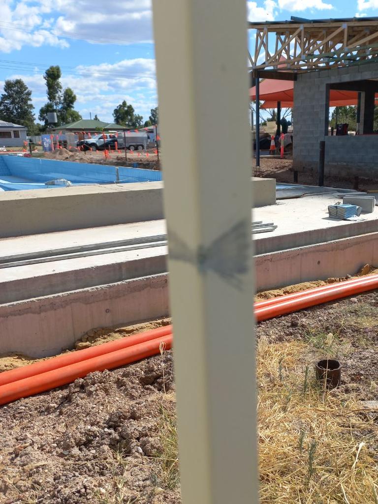 Marking left by a stray bullet that hit the back fencing at the pool worksite near electricians. Picture: Supplied