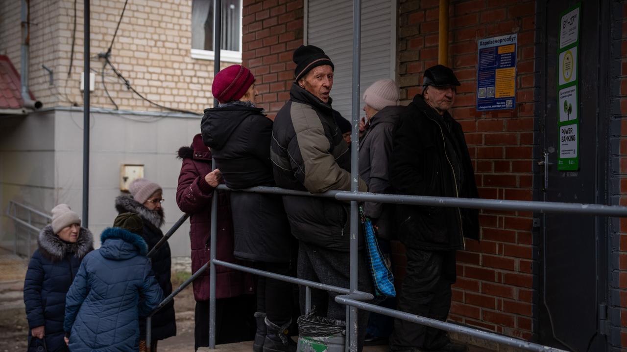People queue outside a bank that closed during an air raid alert on January 21, 2025 in Izyum, Ukraine. Picture: Carl Court/Getty Images