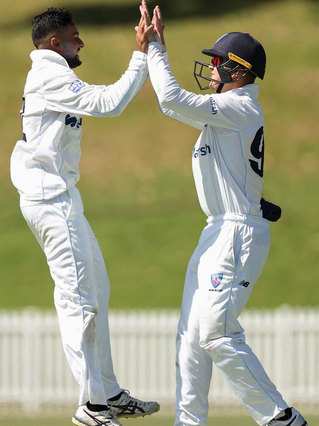 Tanveer Sangha celebrates with Matthew Gilkes.