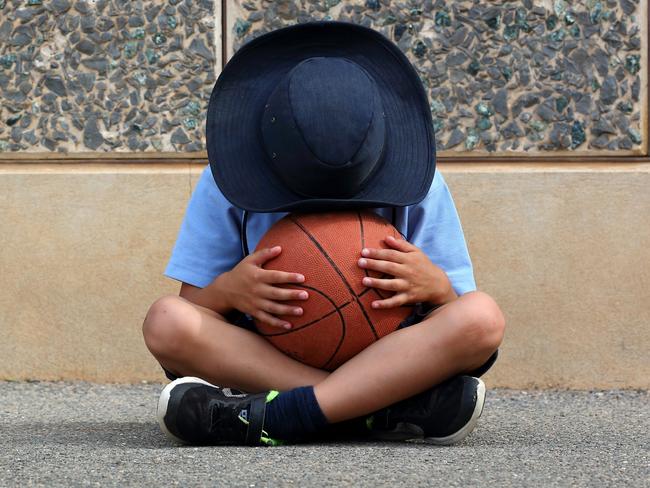 Unhappy child in the schoolyard.