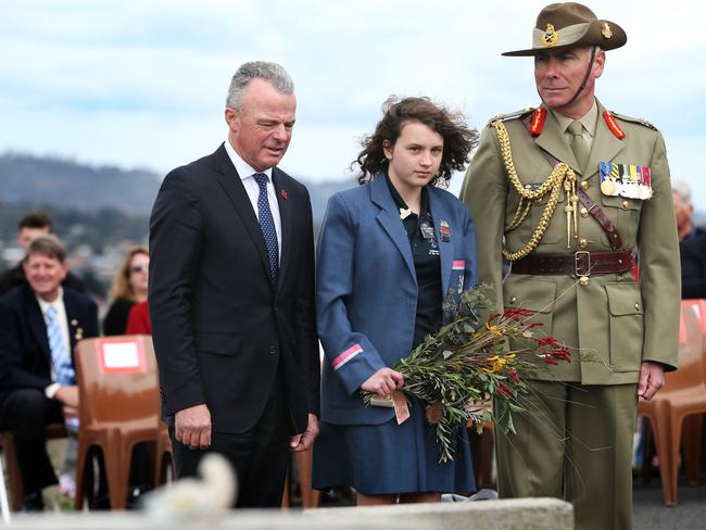 Australian War Memorial director Dr Brendan Nelson, left,  Rose Bay High student Lily Connor, 14, and   Major General Steven Smith at the grave of Sapper Louis Richard Morgan during the unveiling of 14 headstones as part of the Tasmanian Headstone Project. Picture: NIKKI DAVIS-JONES