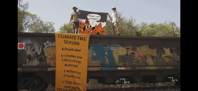 Two climate protesters on a coal train at Lytton.