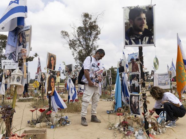 RE'EIM, ISRAEL - APRIL 7: Sigal Manzuri and Amit Cohen visit the marker of their daughters Norelle and Roya who were killed on the October 7 Hamas deadly attack at the Nova music festival on April 7, 2024 in Re'eim, Israel. April 7th marks six months since Hamas led an attack on Israel, killing 1,200 people and taking around 250 people hostage. In response, Israel launched a retaliatory war in Gaza that has killed more than 33,000 people, according to the Gazan health ministry. As the latest round of ceasefire negotiations have stalled, the humanitarian crisis worsens in Gaza, while more than 100 Israeli hostages remain in captivity. (Photo by Amir Levy/Getty Images)