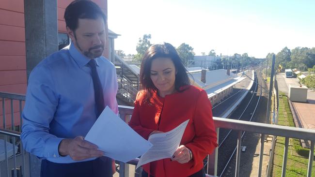 Federal Labor MPs Ed Husic and Emma Husar examine plans at St Marys station for the party's proposed north-south rail link in western Sydney.