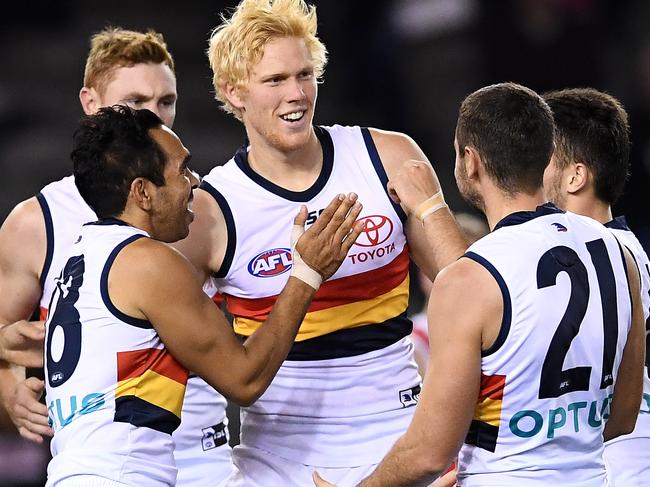 Crows youngster Elliott Himmelberg is congratulated by teammates after kicking a goal during Adelaide’s 29-point win over St Kilda. Picture: Quinn Rooney/Getty Images