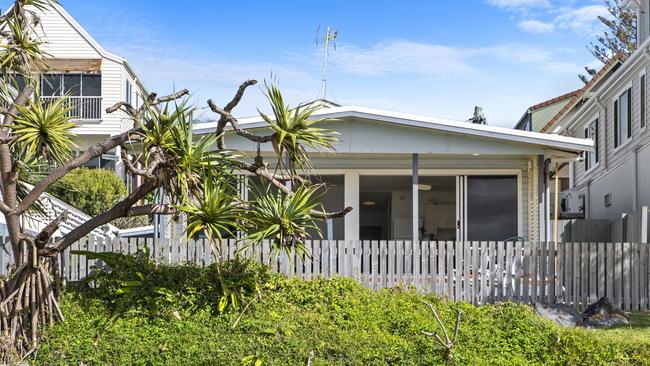 Nestled among a string of beachside mansions with millionaire owners, the quaint retro home has been a holiday home since 1978.